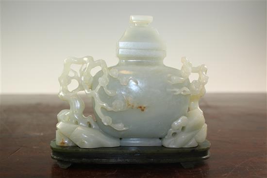 A Chinese pale celadon jade vase and cover, with spinach green jade stand, Qing dynasty or later, 4.3cm., width 13.5cm., fitted rosewoo